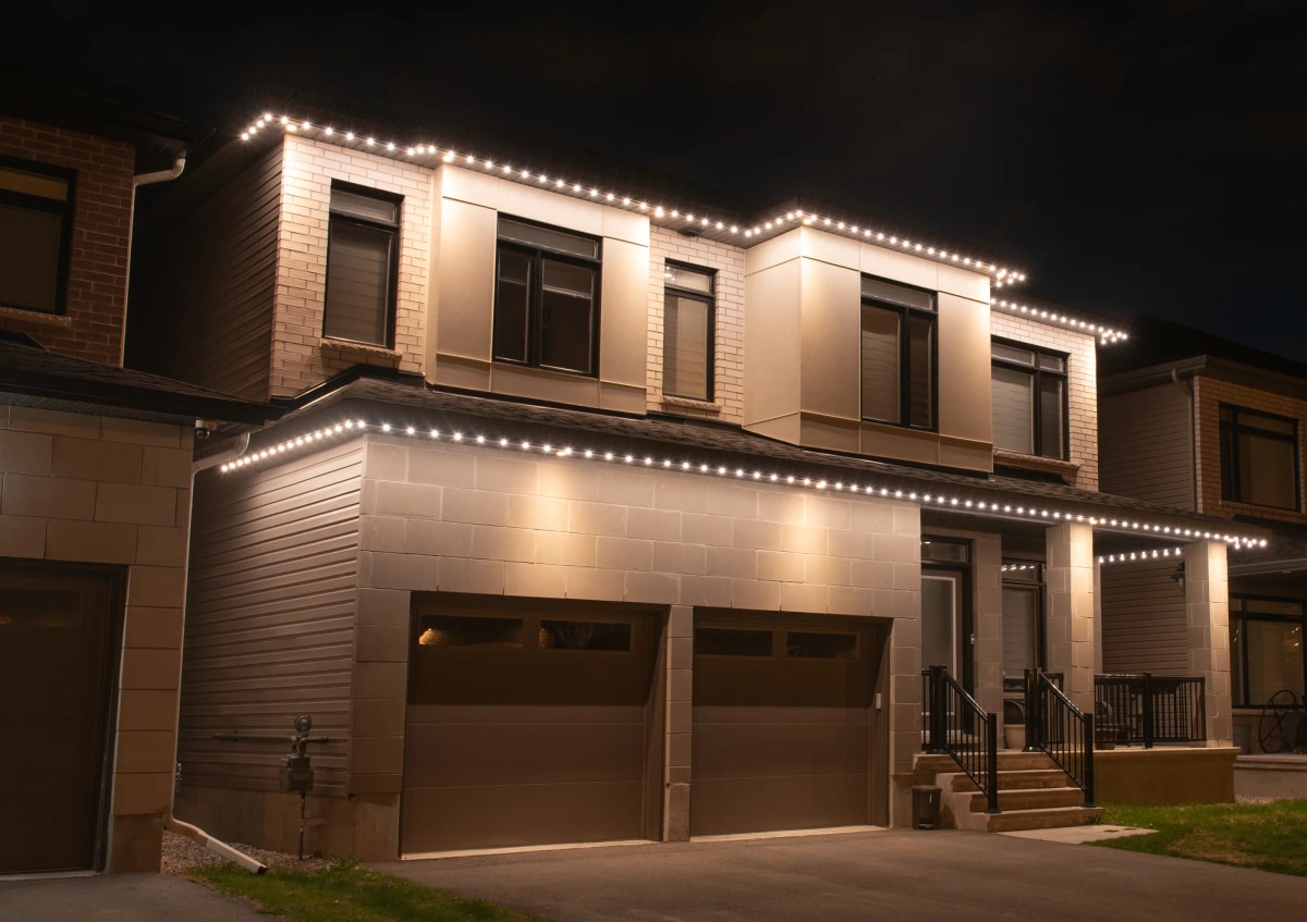 Modern home with warm white permanent roofline lighting